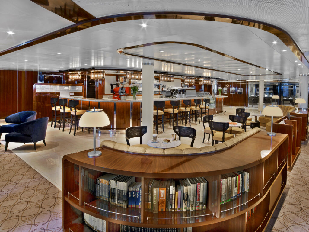 The sophisticated all-day café and gathering place Seabourn Square, with its curved central counter and inviting seating